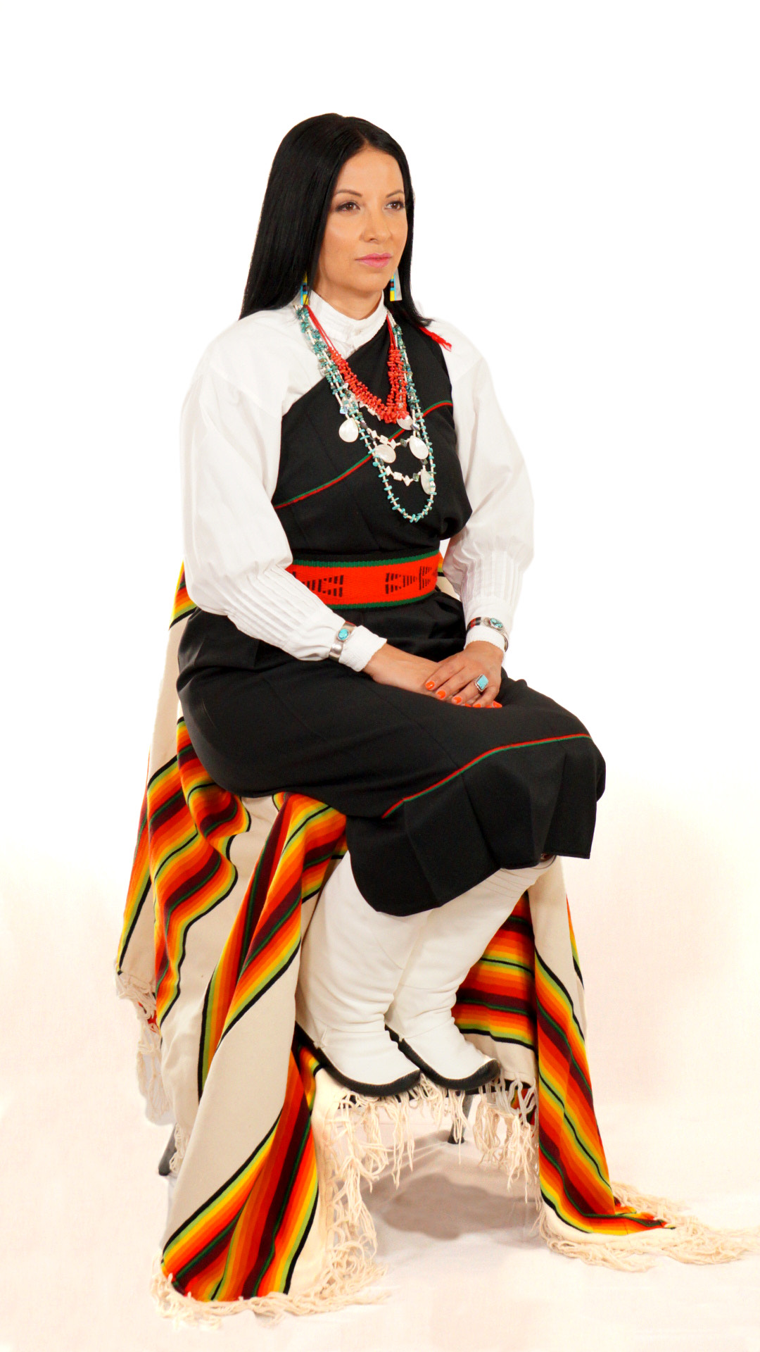 woman sitting in traditional pueblo dress